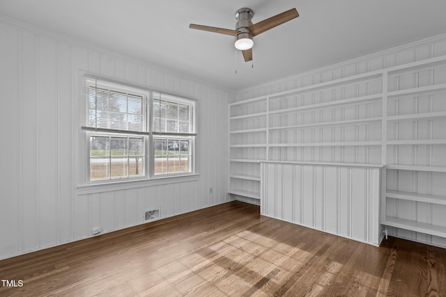 unfurnished bedroom with ceiling fan, wood-type flooring, and crown molding