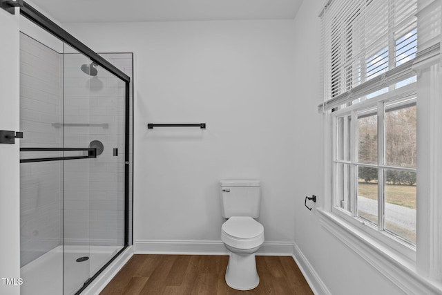 bathroom featuring hardwood / wood-style flooring, toilet, and an enclosed shower