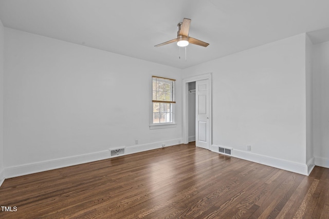 empty room featuring dark hardwood / wood-style floors and ceiling fan