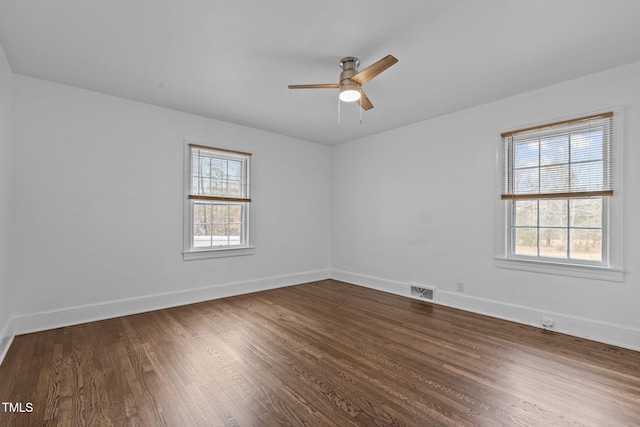 unfurnished room featuring hardwood / wood-style floors, ceiling fan, and a healthy amount of sunlight