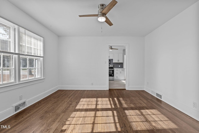 spare room with dark wood-type flooring