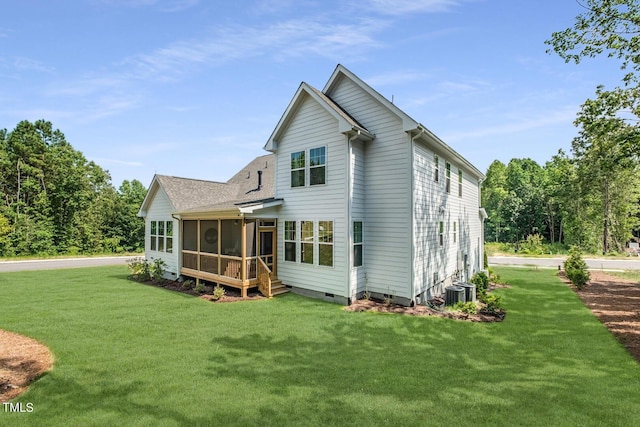 back of property with a sunroom, cooling unit, and a yard