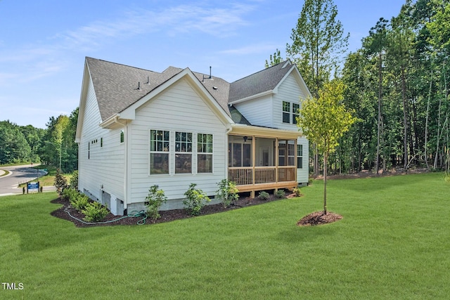 back of house with a yard and a sunroom