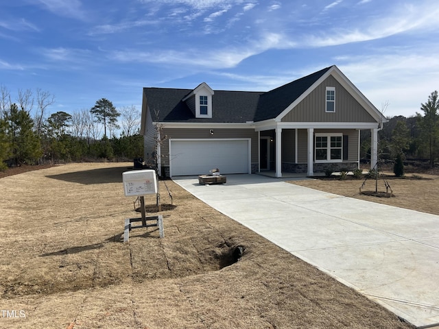 view of front of house with a porch and a garage