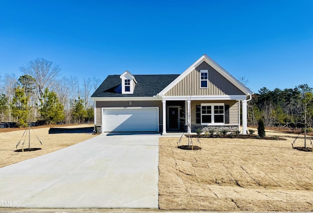 view of front facade with board and batten siding, concrete driveway, roof with shingles, and an attached garage