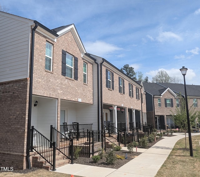 view of front of property featuring brick siding and a residential view