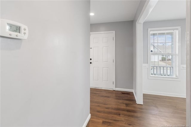 hall with dark wood-type flooring