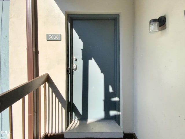 5038 Flint Ridge Pl, Raleigh, NC 27609 - doorway to property featuring stucco siding