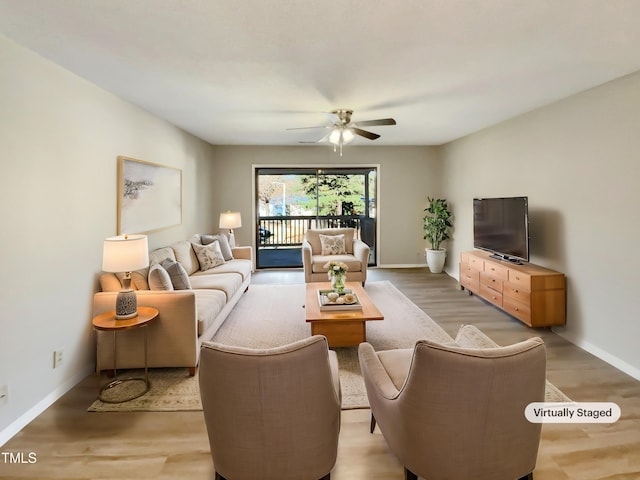 living room featuring wood-type flooring and ceiling fan