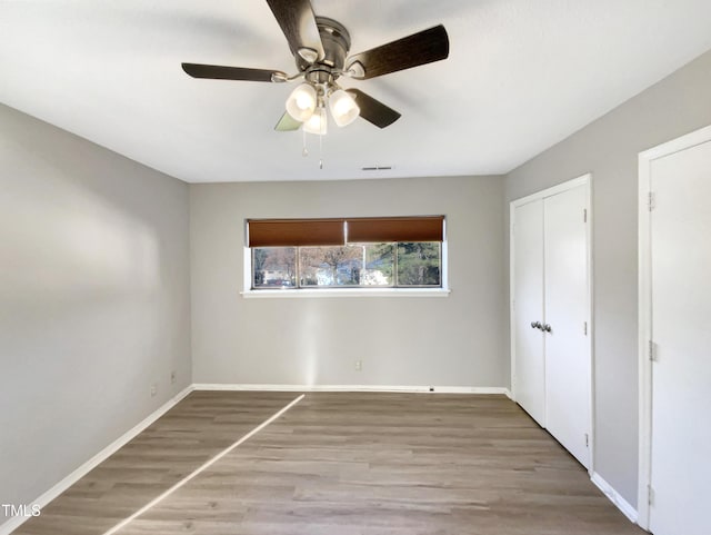 unfurnished bedroom featuring ceiling fan and hardwood / wood-style floors