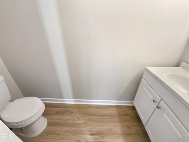 bathroom featuring vanity, toilet, and wood-type flooring