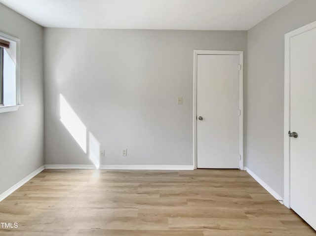 spare room featuring light wood-type flooring