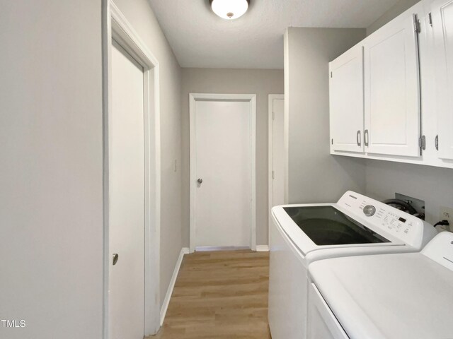 5038 Flint Ridge Pl, Raleigh, NC 27609 - laundry room with washer and dryer, cabinet space, and light wood-type flooring