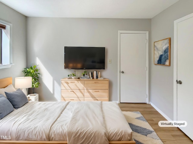 5038 Flint Ridge Pl, Raleigh, NC 27609 - bedroom with light wood-type flooring and baseboards