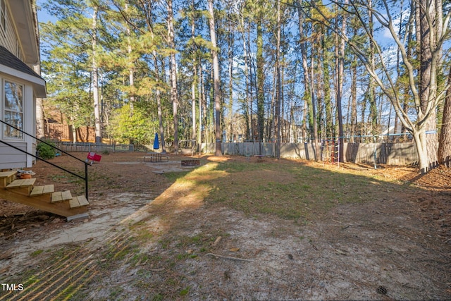 view of yard featuring an outdoor fire pit