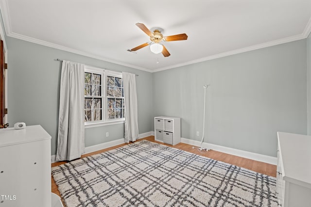 unfurnished bedroom featuring ceiling fan, crown molding, and light hardwood / wood-style flooring