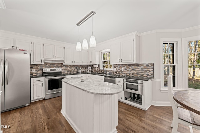 kitchen featuring appliances with stainless steel finishes, white cabinetry, and a kitchen island