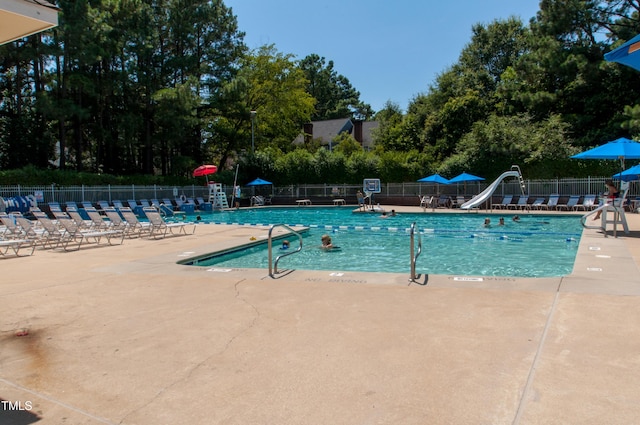 view of pool with a patio area and a water slide