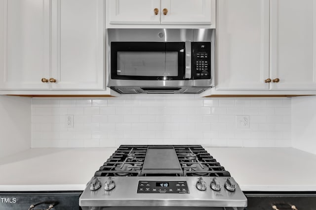 kitchen with white cabinets and decorative backsplash