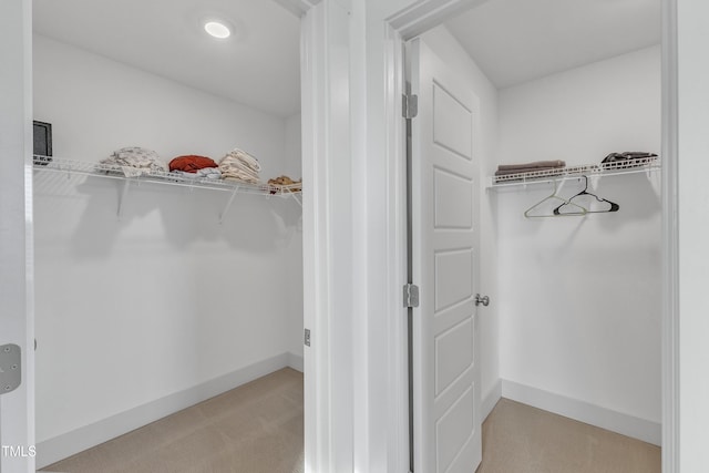 spacious closet featuring light carpet