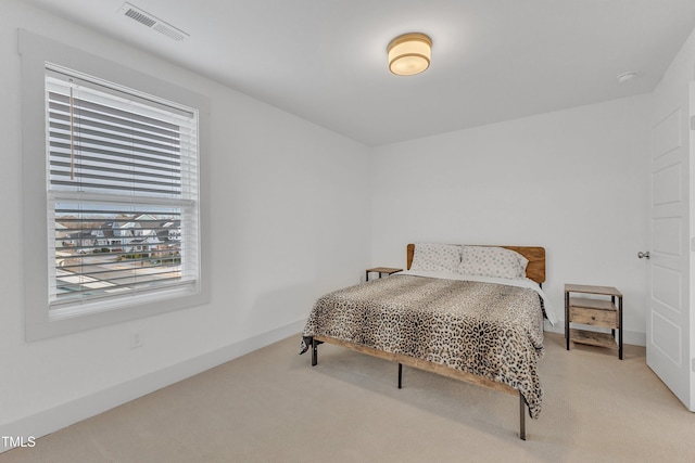 bedroom featuring light colored carpet