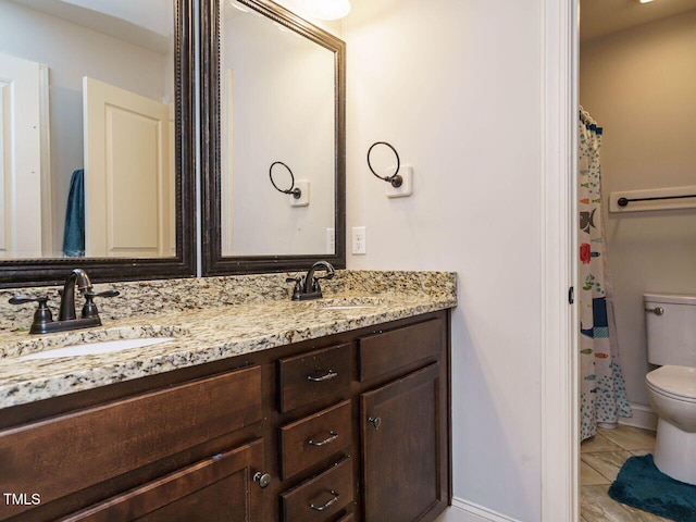 bathroom featuring tile patterned flooring, vanity, and toilet