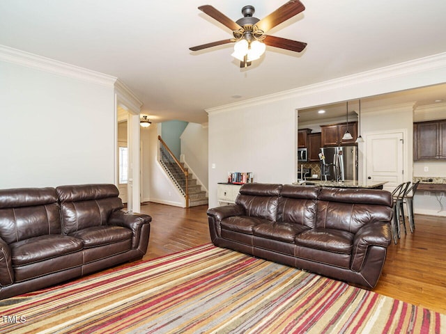 living room with wood-type flooring and ornamental molding