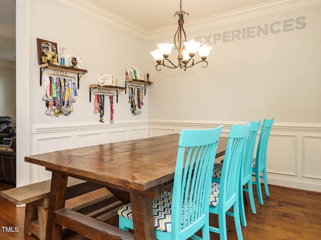 dining room with ornamental molding, dark hardwood / wood-style flooring, and a notable chandelier