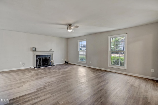 unfurnished living room featuring light wood-type flooring and ceiling fan