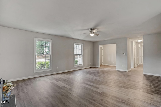 empty room with hardwood / wood-style floors and ceiling fan