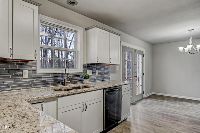 kitchen featuring white cabinetry, dishwasher, light wood-type flooring, and sink