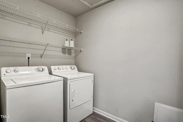 laundry area with dark hardwood / wood-style flooring and washer and clothes dryer