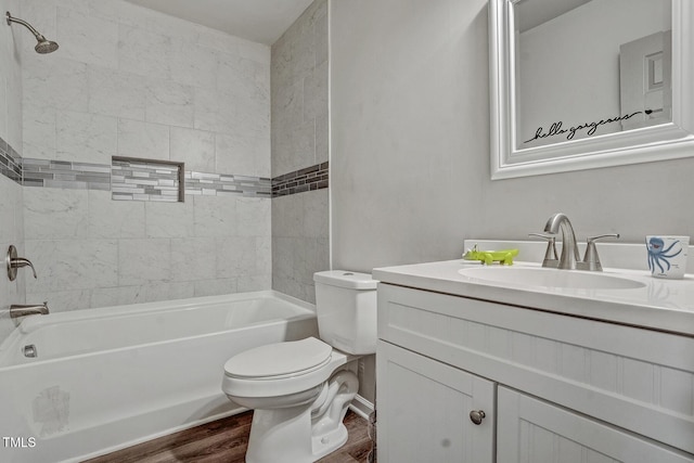 full bathroom with toilet, vanity, tiled shower / bath combo, and hardwood / wood-style flooring