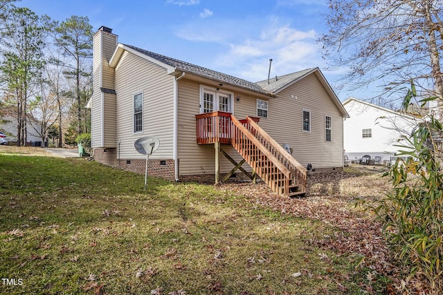 rear view of house featuring french doors and a yard