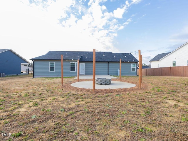 back of house featuring a lawn and a patio area