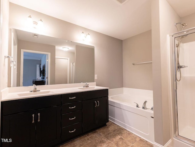 bathroom with vanity and separate shower and tub