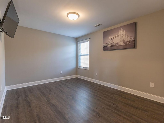 empty room with dark wood-type flooring