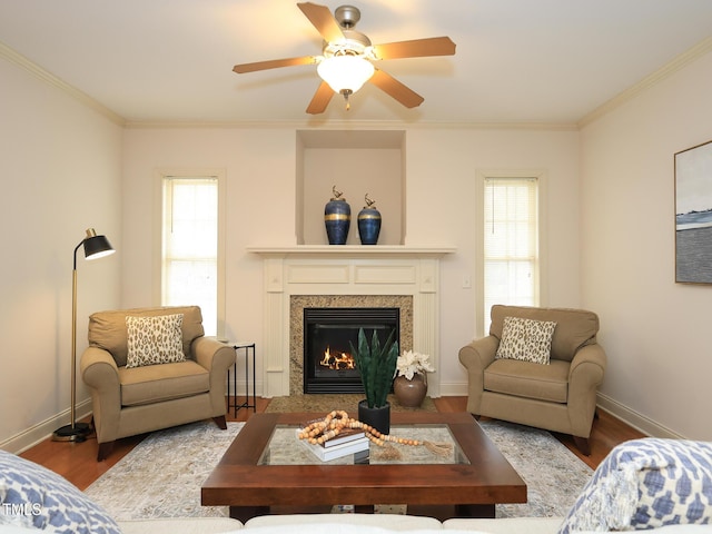 living room with hardwood / wood-style flooring, ceiling fan, and ornamental molding