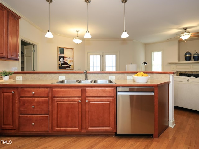 kitchen with dishwasher, pendant lighting, light wood-type flooring, and ornamental molding