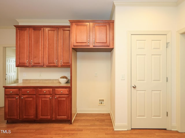 kitchen featuring light hardwood / wood-style floors and ornamental molding