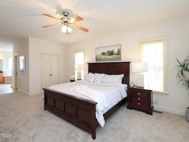 carpeted bedroom with ceiling fan and a closet