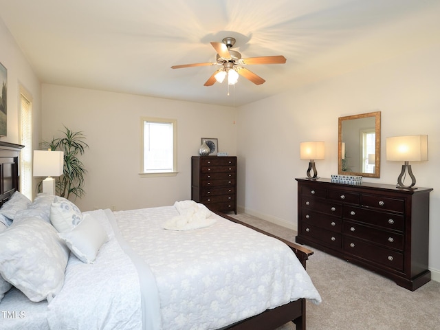 bedroom with ceiling fan and light colored carpet