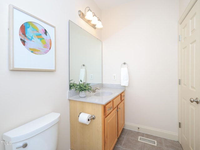 bathroom featuring tile patterned floors, vanity, and toilet