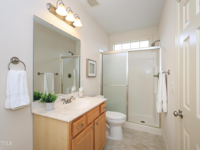 bathroom featuring toilet, vanity, and walk in shower