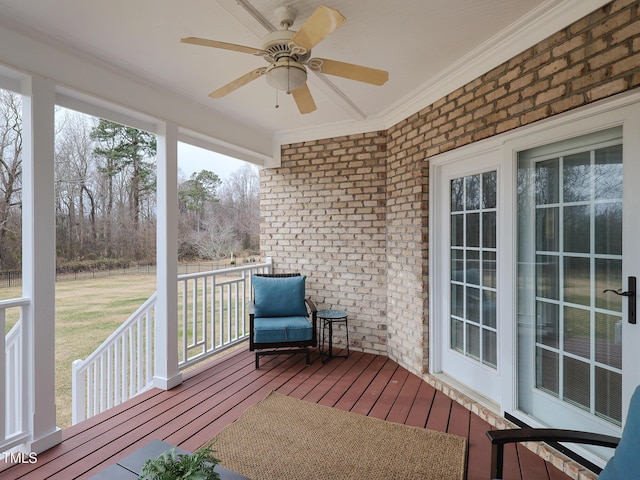 unfurnished sunroom with ceiling fan