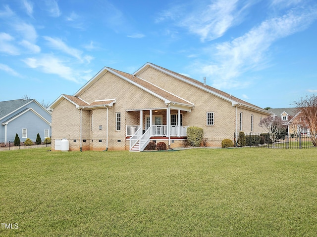 back of property with a lawn and a porch