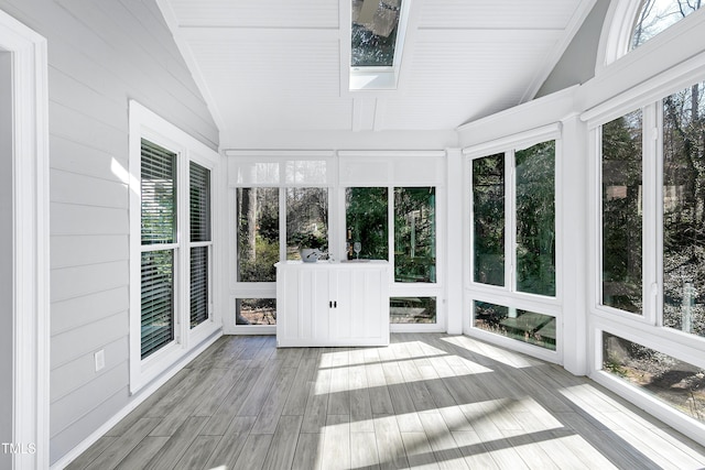 unfurnished sunroom featuring vaulted ceiling