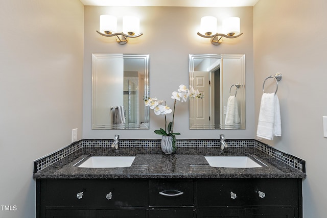 full bathroom with double vanity and a sink