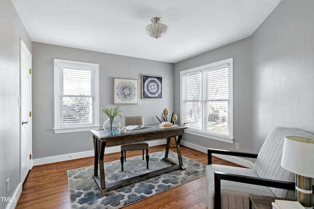 office featuring baseboards, dark wood-style flooring, and a healthy amount of sunlight