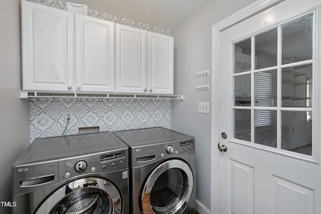 laundry area featuring cabinet space and separate washer and dryer